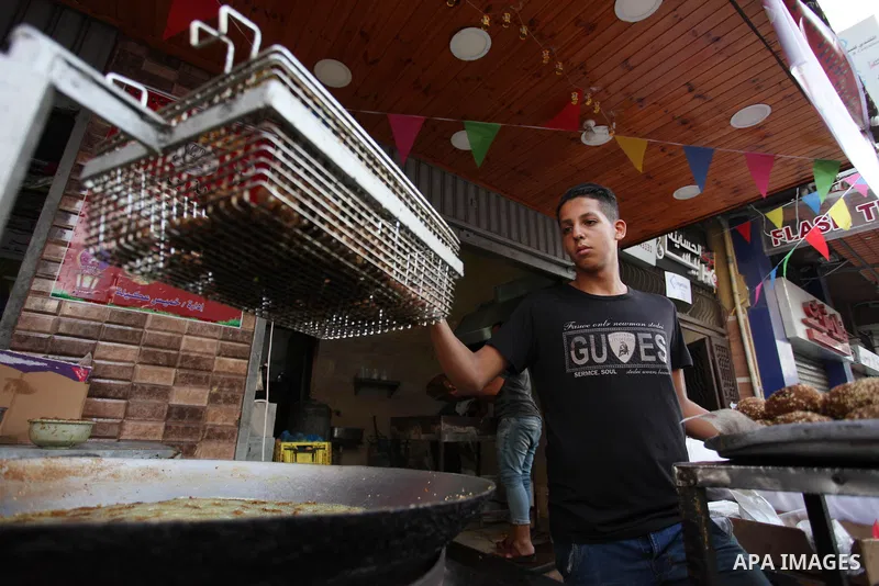 A Palestinian vendor prepares traditional chickpeas known as "Falafel" for breakfasting on the Muslim holy fasting month of Ramadan in Gaza city on May 21, 2018. Ramadan is sacred to Muslims because it is during that mon...