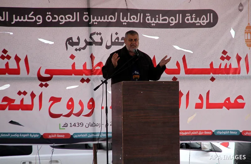 Khaled al-Batsh, senior leader of the Islamic Jihad movement, head of the supreme commission for the "Great Return March" speaks as he attends the breakfast meal at the Israel-Gaza border, in east of Gaza city, on May 23...