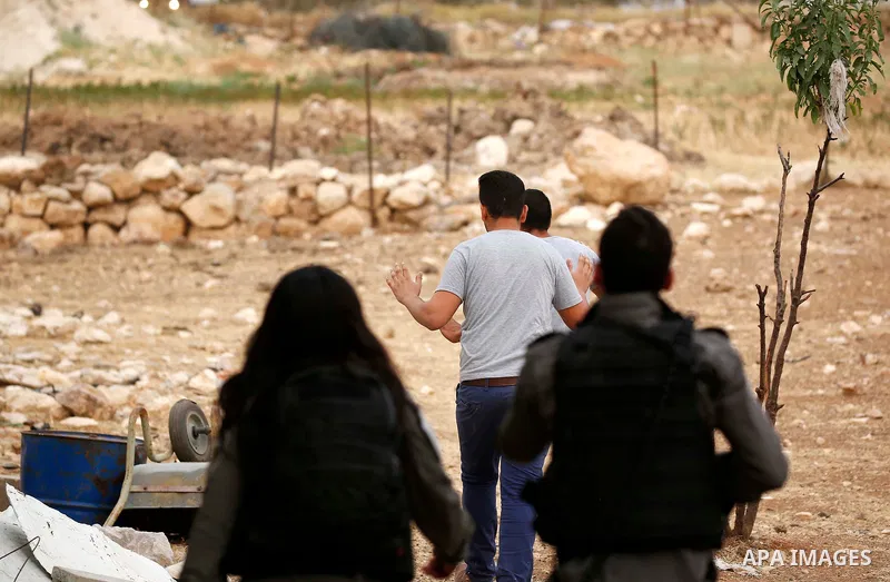 Israeli policemen detain Palestinians as they try to make their way to attend the second Friday prayer of the holy fasting month of Ramadan in Jerusalem's Al-Aqsa mosque, after Israeli police prevented them from crossing...