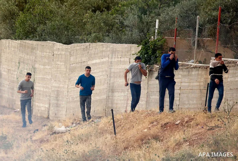 Palestinians try to make their way to attend the second Friday prayer of the holy fasting month of Ramadan in Jerusalem's Al-Aqsa mosque, after Israeli police prevented them from crossing to pray, in the West Bank city o...