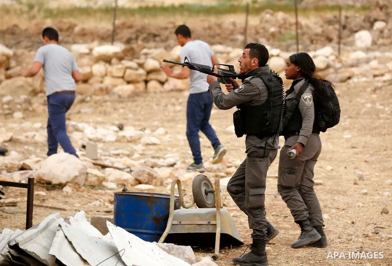 Israeli policemen stand guard as Palestinians try to make their way to attend the second Friday prayer of the holy fasting month of Ramadan in Jerusalem's Al-Aqsa mosque, after Israeli police prevented them from crossing...