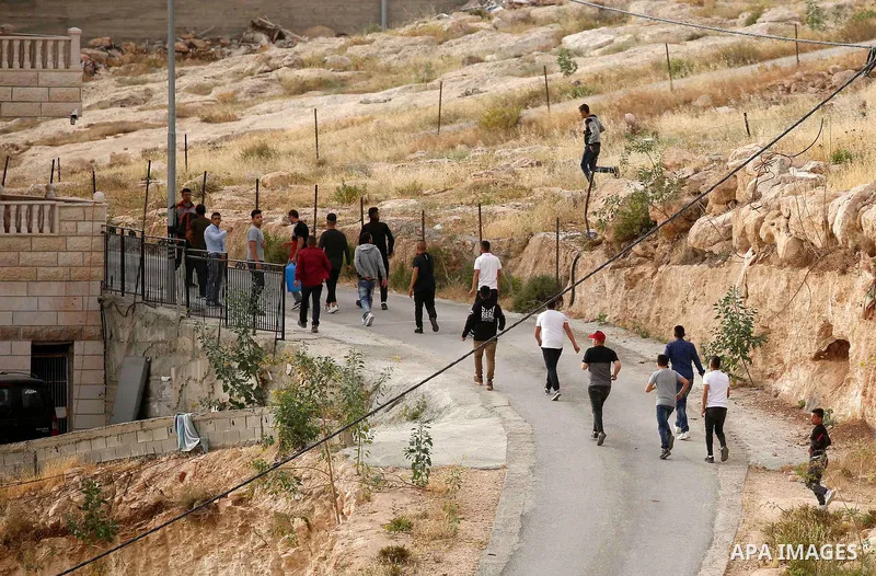 Palestinians try to make their way to attend the second Friday prayer of the holy fasting month of Ramadan in Jerusalem's Al-Aqsa mosque, after Israeli police prevented them from crossing to pray, in the West Bank city o...