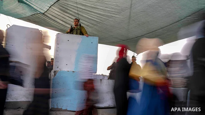 Palestinians make their way through Qalandia checkpoint to attend the second Friday prayer of the holy fasting month of Ramadan in Jerusalem's Al-Aqsa mosque, near Ramallah in the occupied West Bank, on May 25, 2018. Ram...