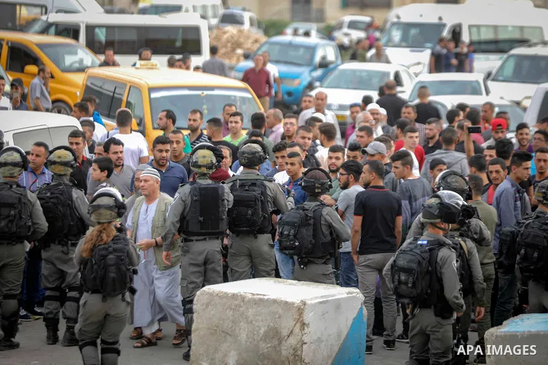 Palestinians make their way through Qalandia checkpoint to attend the second Friday prayer of the holy fasting month of Ramadan in Jerusalem's Al-Aqsa mosque, near Ramallah in the occupied West Bank, on May 25, 2018. Ram...