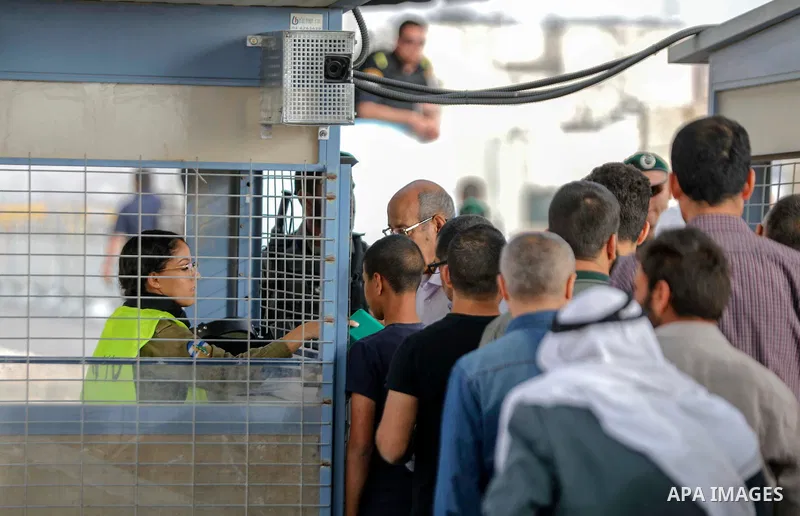 Palestinians make their way through Qalandia checkpoint to attend the second Friday prayer of the holy fasting month of Ramadan in Jerusalem's Al-Aqsa mosque, near Ramallah in the occupied West Bank, on May 25, 2018. Ram...
