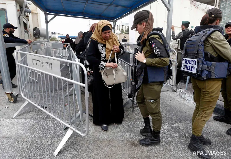 Palestinians make their way through an Israeli checkpoint to attend the second Friday prayer of the holy fasting month of Ramadan in Jerusalem's Al-Aqsa mosque, in Bethlehem in the occupied West Bank, on May 25, 2018. Ra...