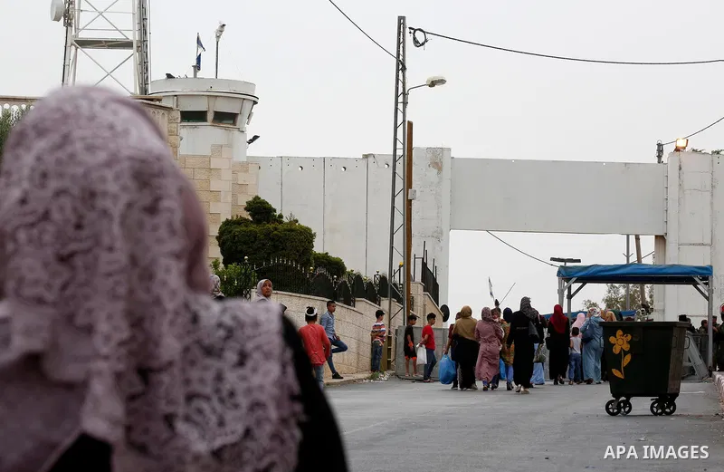Palestinians make their way through an Israeli checkpoint to attend the second Friday prayer of the holy fasting month of Ramadan in Jerusalem's Al-Aqsa mosque, in Bethlehem in the occupied West Bank, on May 25, 2018. Ra...
