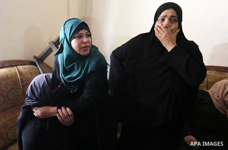 Relatives of Palestinian Ahmed Qutoosh, 23, who died of his wounds endured during clashes with Israeli troops in a tent city protest where Palestinians demand the right to return to their homeland at the Israel-Gaza bord...