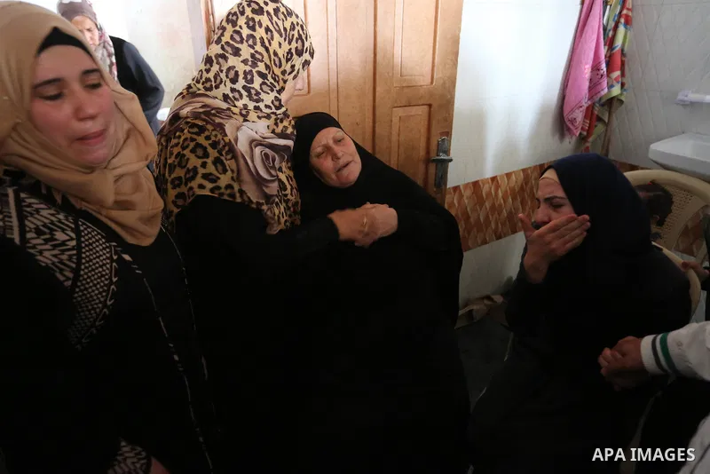 Relatives of Palestinian Ahmed Qutoosh, 23, who died of his wounds endured during clashes with Israeli troops in a tent city protest where Palestinians demand the right to return to their homeland at the Israel-Gaza bord...