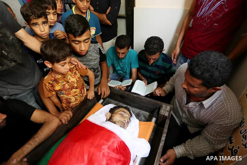 Relatives of Palestinian Ahmed Qutoosh, 23, who died of his wounds endured during clashes with Israeli troops in a tent city protest where Palestinians demand the right to return to their homeland at the Israel-Gaza bord...