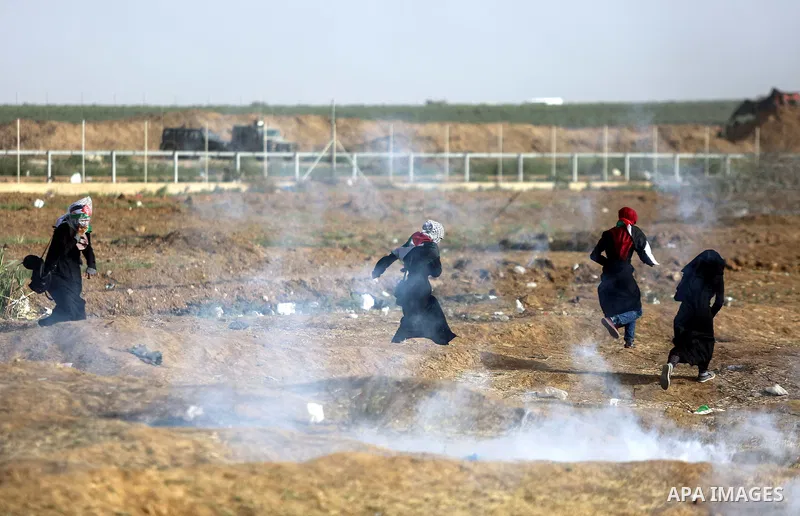 Palestinian protesters gather during clashes with Israeli security froces in a tent city protest where Palestinians demand the right to return to their homeland and against U.S. embassy move to Jerusalem at the Israel-Ga...
