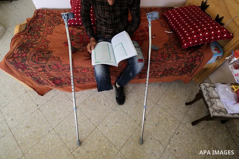 Palestinian Mohammed Musabeh, 17, a High school student, who amputated his leg after he was shot by Israeli troops during clashes in tents protest demanding the right to return to their homeland, at the Israel-Gaza borde...