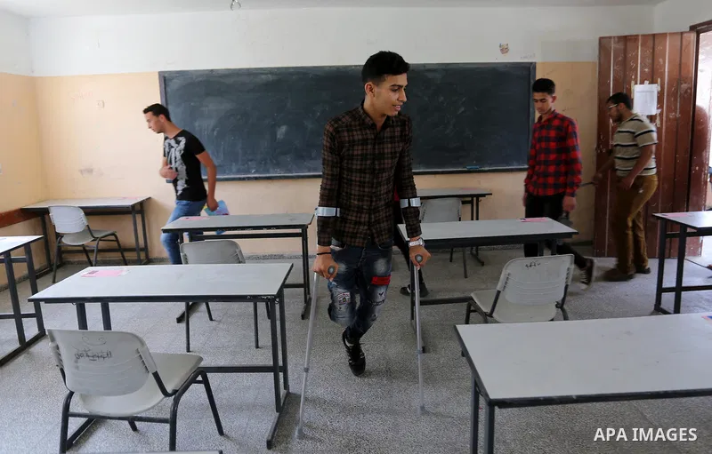 Palestinian Mohammed Musabeh, 17, a High school student, who amputated his leg after he was shot by Israeli troops during clashes in tents protest demanding the right to return to their homeland, at the Israel-Gaza borde...