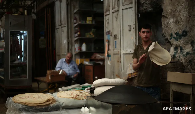 A Palestinian vendor prepares bread during the holy month of Ramadan in the West Bank city of Nablus on May 26, 2018. Ramadan is sacred to Muslims because it is during that month that tradition says the Koran was reveale...