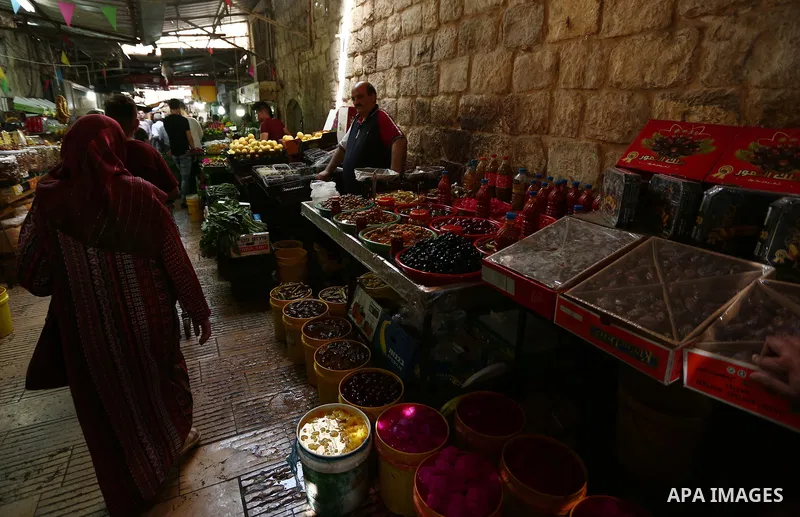 Palestinians shop at a market during the holy month of Ramadan in the West Bank city of Nablus on May 26, 2018. Ramadan is sacred to Muslims because it is during that month that tradition says the Koran was revealed to t...