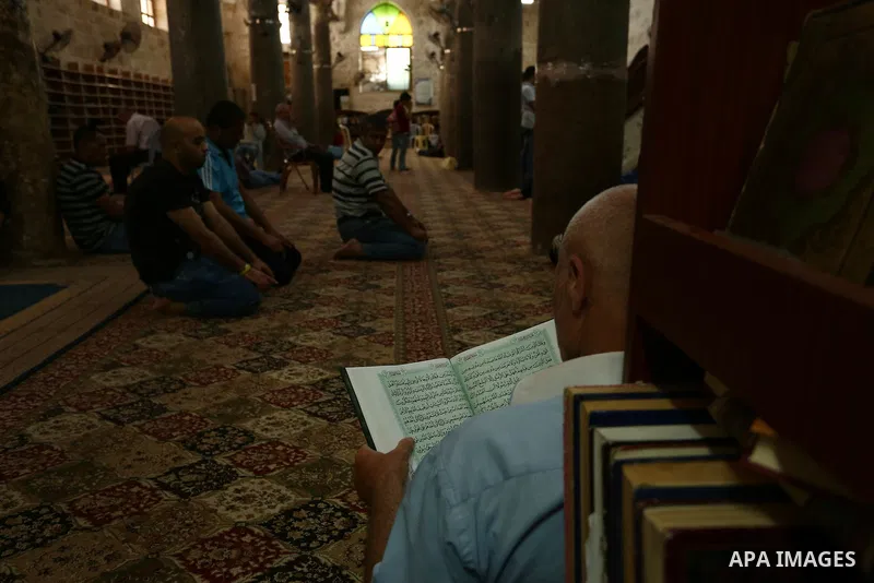 Palestinians read the Koran, Islam's holiest book, at a mosque in Gaza City on the Muslim holy month of Ramadan in the West Bank city of Nablus on May 26, 2018. Ramadan is sacred to Muslims because it is during that mont...