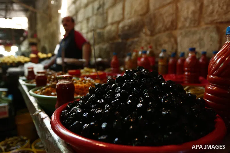 Palestinians shop at a market during the holy month of Ramadan in the West Bank city of Nablus on May 26, 2018. Ramadan is sacred to Muslims because it is during that month that tradition says the Koran was revealed to t...