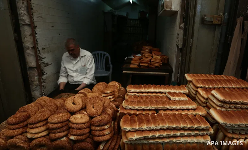 A Palestinian vendor prepares sweets at a market during the holy month of Ramadan in the West Bank city of Nablus on May 26, 2018. Ramadan is sacred to Muslims because it is during that month that tradition says the Kora...