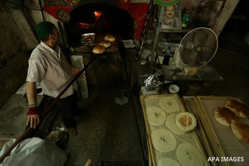 A Palestinian vendor prepares bread during the holy month of Ramadan in the West Bank city of Nablus on May 26, 2018. Ramadan is sacred to Muslims because it is during that month that tradition says the Koran was reveale...
