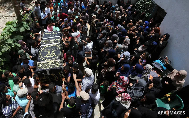 Mourners carry a casket containing the body of a Palestinian Islamic Jihad militant Abdel Halim al-Naqa, 28, who was killed in Israeli tank fire earlier in the day, during his funeral in Khan Younis in the southern Gaza...