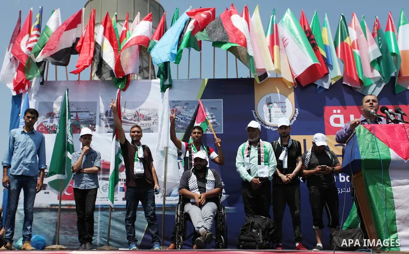 Palestinian activists prepare themselves to ride fishing boats as they protesting and perhaps trying to breach Israel's naval blockade on Gaza, setting to sail from Gaza City harbour towards Europe on May 29, 2018. Pales...