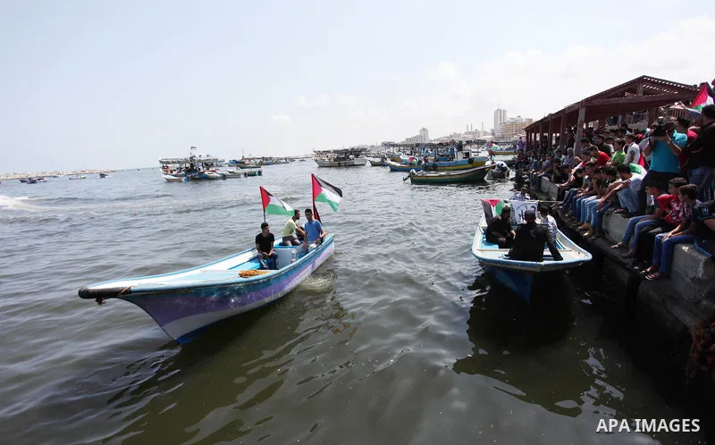 Palestinian activists ride fishing boats as they protesting and perhaps trying to breach Israel's naval blockade on Gaza, setting to sail from Gaza City harbour towards Europe on May 29, 2018. Palestinians in Gaza are pl...