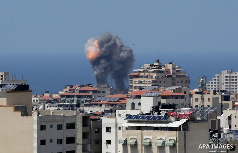 A picture taken from Gaza City on May 29, 2018, shows a smoke billowing in the background following an Israeli air strike on the Palestinian enclave. The Israeli military launched a series of air strikes on Palestinian p...