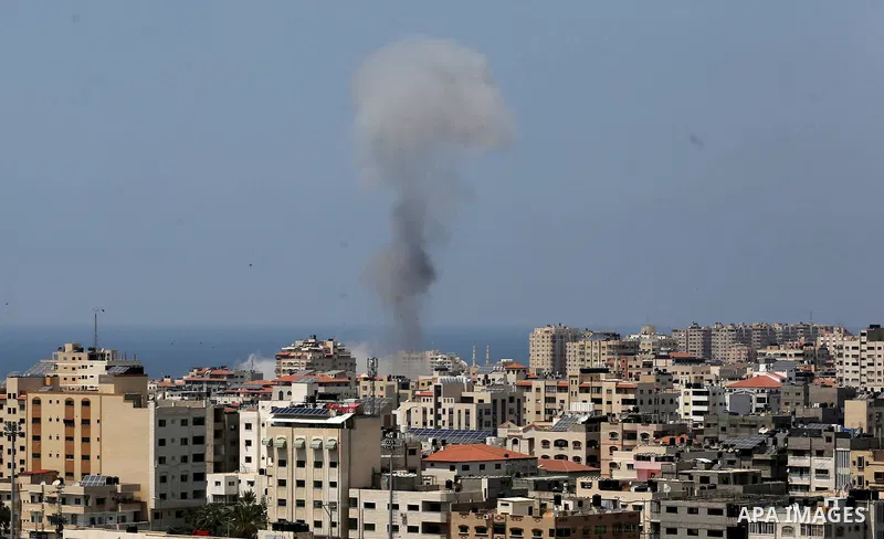 A picture taken from Gaza City on May 29, 2018, shows a smoke billowing in the background following an Israeli air strike on the Palestinian enclave. The Israeli military launched a series of air strikes on Palestinian p...