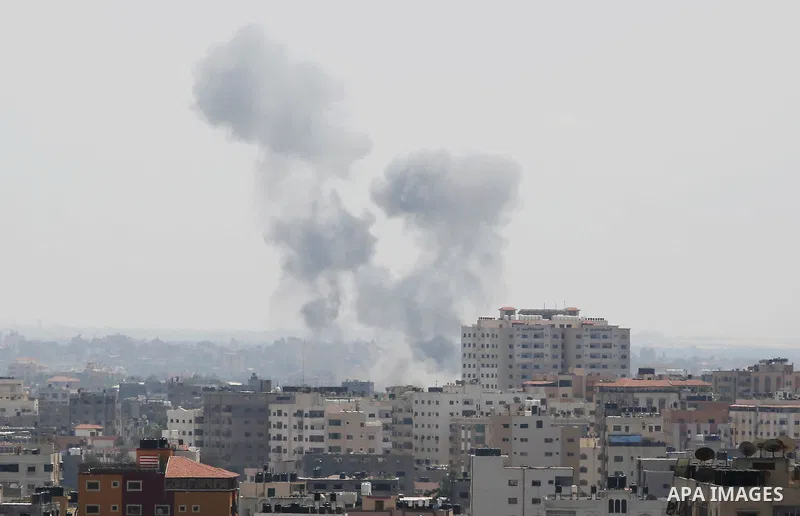 A picture taken from Gaza City on May 29, 2018, shows a smoke billowing in the background following an Israeli air strike on the Palestinian enclave. The Israeli military launched a series of air strikes on Palestinian p...