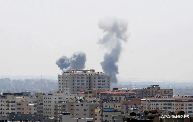 A picture taken from Gaza City on May 29, 2018, shows a smoke billowing in the background following an Israeli air strike on the Palestinian enclave. The Israeli military launched a series of air strikes on Palestinian p...