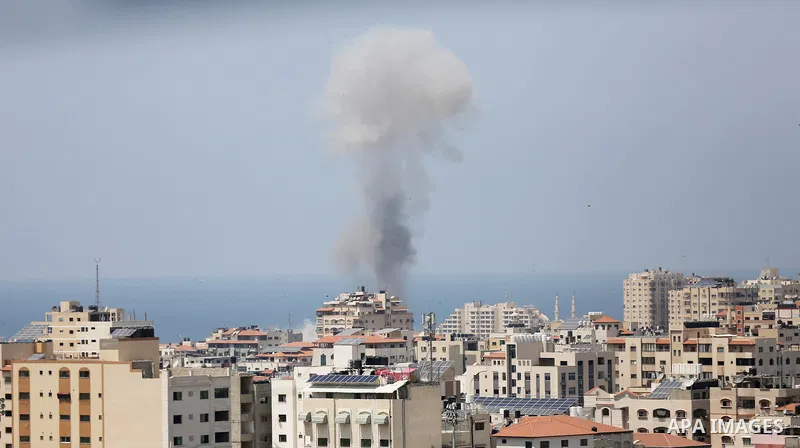 A picture taken from Gaza City on May 29, 2018, shows a smoke billowing in the background following an Israeli air strike on the Palestinian enclave. The Israeli military launched a series of air strikes on Palestinian p...