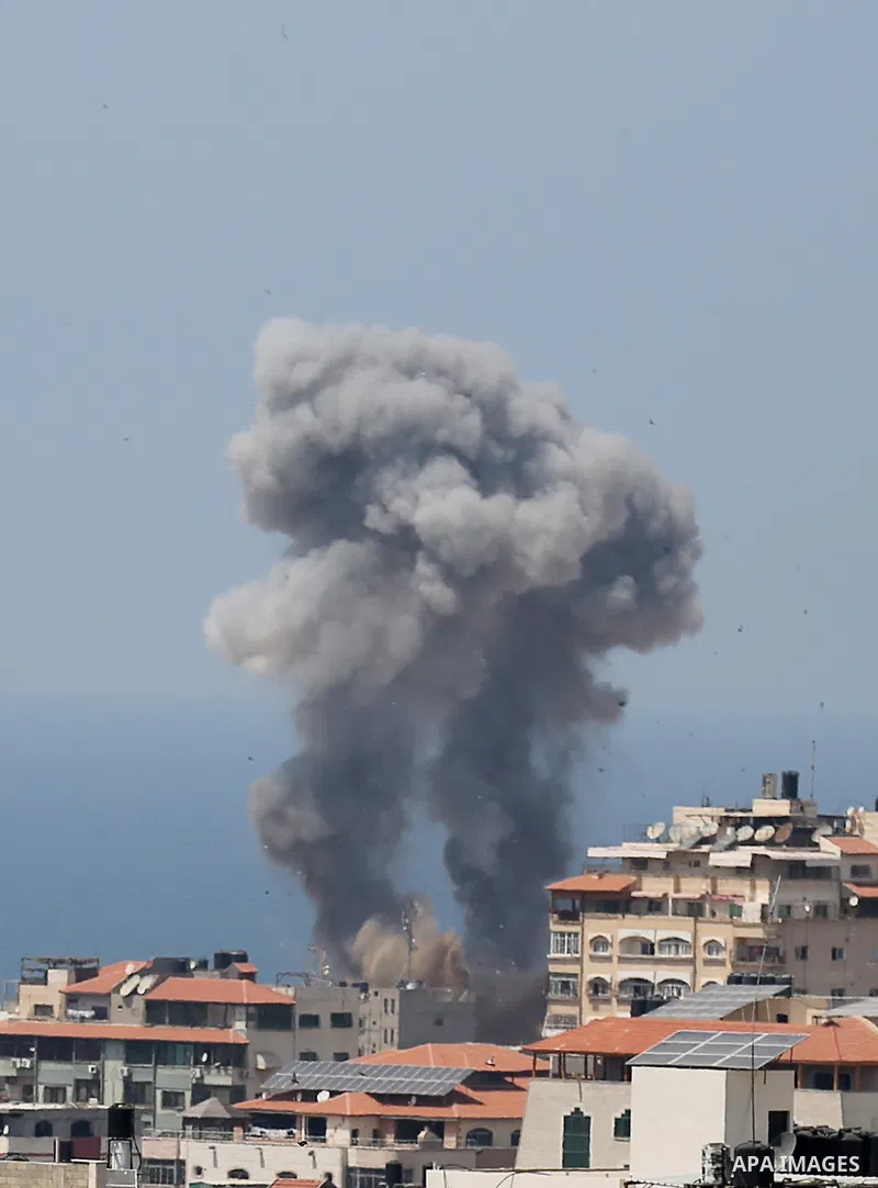 A picture taken from Gaza City on May 29, 2018, shows a smoke billowing in the background following an Israeli air strike on the Palestinian enclave. The Israeli military launched a series of air strikes on Palestinian p...