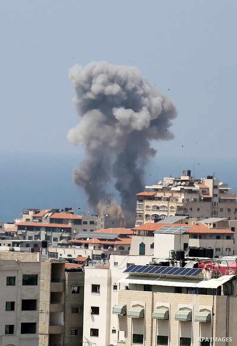 A picture taken from Gaza City on May 29, 2018, shows a smoke billowing in the background following an Israeli air strike on the Palestinian enclave. The Israeli military launched a series of air strikes on Palestinian p...