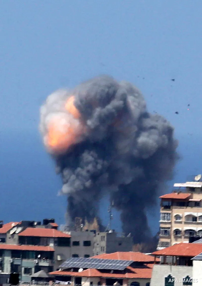 A picture taken from Gaza City on May 29, 2018, shows a smoke billowing in the background following an Israeli air strike on the Palestinian enclave. The Israeli military launched a series of air strikes on Palestinian p...
