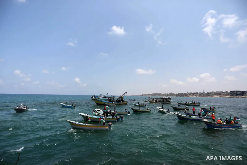 Palestinian activists ride fishing boats as they protesting and perhaps trying to breach Israel's naval blockade on Gaza, setting to sail from Gaza City harbour towards Europe on May 29, 2018. Palestinians in Gaza are pl...