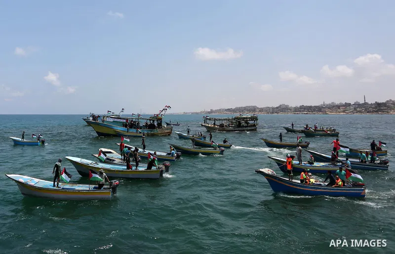 Palestinian activists ride fishing boats as they protesting and perhaps trying to breach Israel's naval blockade on Gaza, setting to sail from Gaza City harbour towards Europe on May 29, 2018. Palestinians in Gaza are pl...