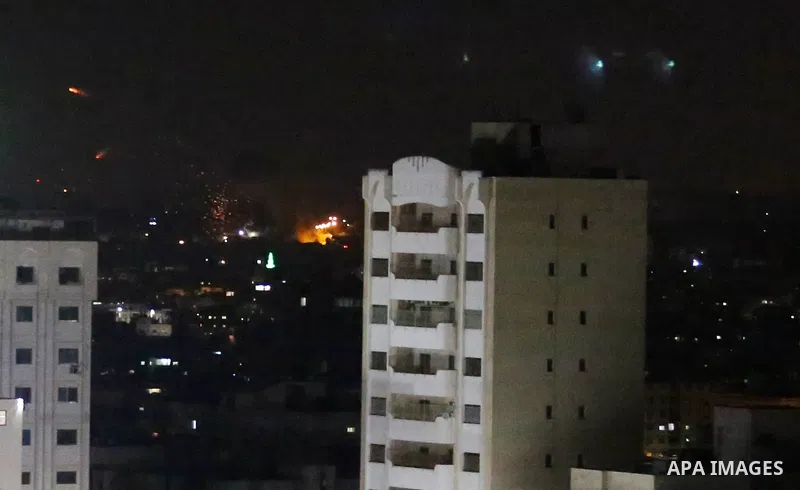 A picture taken from Gaza City on May 30, 2018, shows a fire and smoke billowing in the background following an Israeli air strike on the Palestinian enclave. The Israeli Defense Forces (IDF) said it launched more than 3...