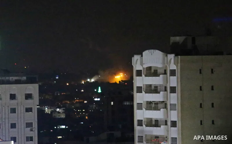 A picture taken from Gaza City on May 30, 2018, shows a fire and smoke billowing in the background following an Israeli air strike on the Palestinian enclave. The Israeli Defense Forces (IDF) said it launched more than 3...