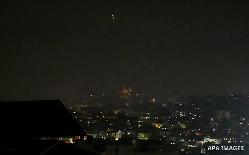 A picture taken from Gaza City on May 30, 2018, shows a fire and smoke billowing in the background following an Israeli air strike on the Palestinian enclave. The Israeli Defense Forces (IDF) said it launched more than 3...