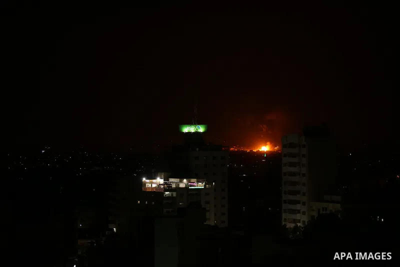A picture taken from Gaza City on May 30, 2018, shows a fire and smoke billowing in the background following an Israeli air strike on the Palestinian enclave. The Israeli Defense Forces (IDF) said it launched more than 3...