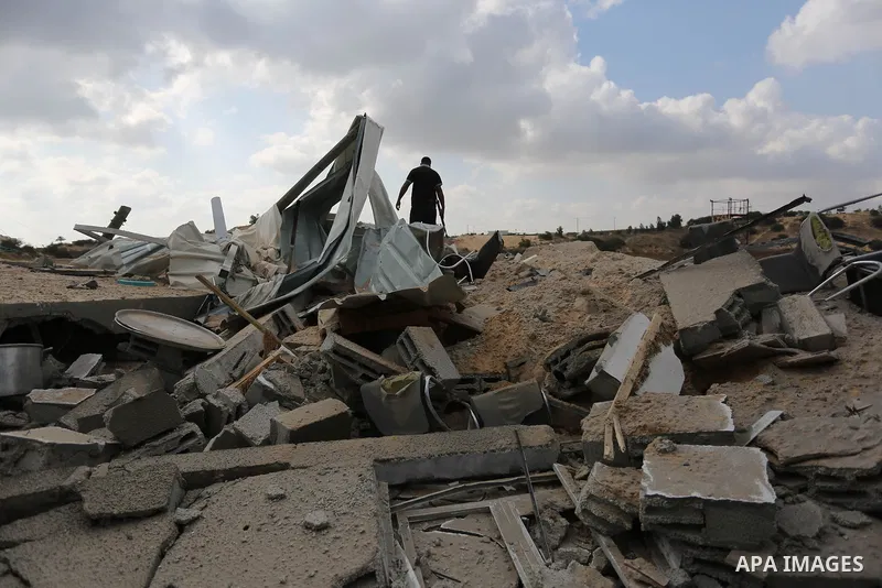 A Palestinian man inspects the site targeted by an Israeli air strike, in Khan younis in the southern Gaza strip, May 30, 2018. The Israeli Defense Forces said it launched more than 35 airstrikes targeting the militant g...