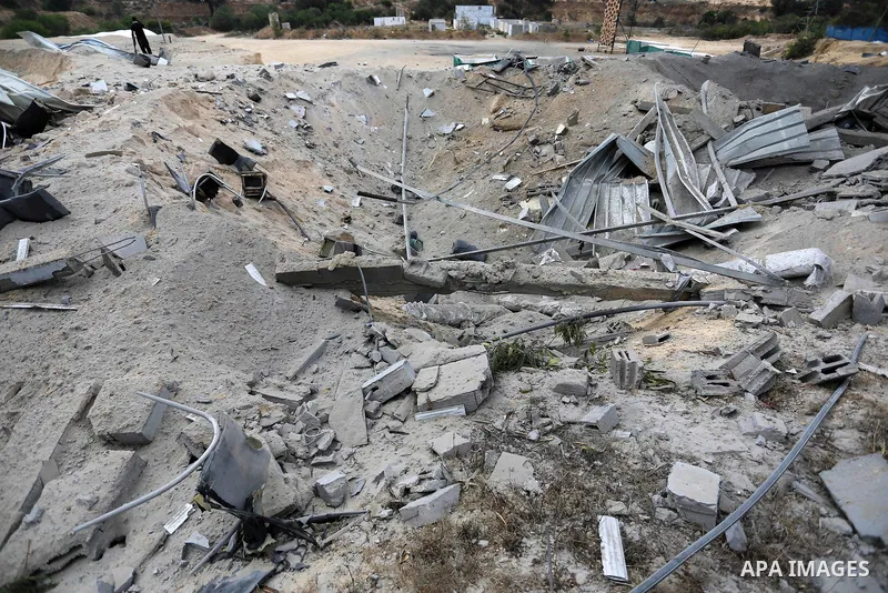 A Palestinian man inspects the site targeted by an Israeli air strike, in Khan younis in the southern Gaza strip, May 30, 2018. The Israeli Defense Forces said it launched more than 35 airstrikes targeting the militant g...