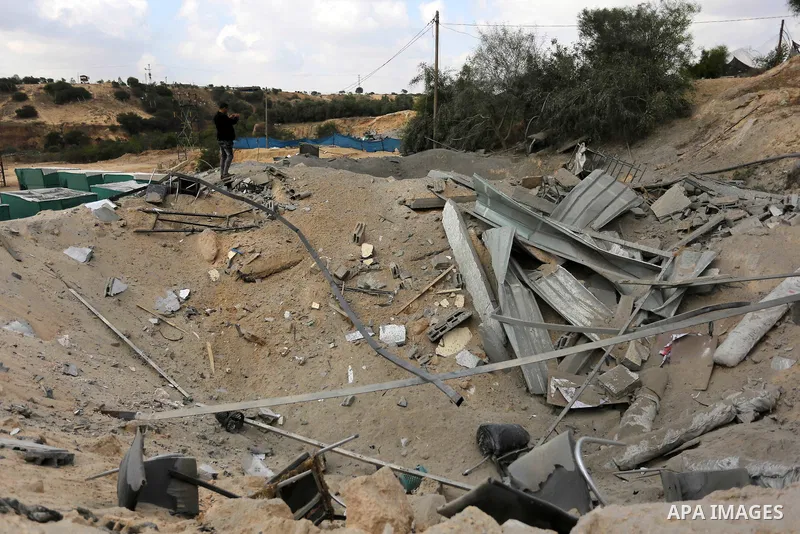 A Palestinian man inspects the site targeted by an Israeli air strike, in Khan younis in the southern Gaza strip, May 30, 2018. The Israeli Defense Forces said it launched more than 35 airstrikes targeting the militant g...