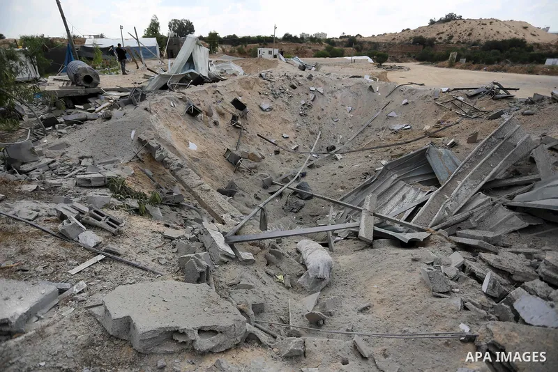 A Palestinian man inspects the site targeted by an Israeli air strike, in Khan younis in the southern Gaza strip, May 30, 2018. The Israeli Defense Forces said it launched more than 35 airstrikes targeting the militant g...