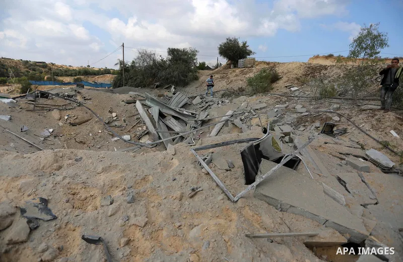 A Palestinian man inspects the site targeted by an Israeli air strike, in Khan younis in the southern Gaza strip, May 30, 2018. The Israeli Defense Forces said it launched more than 35 airstrikes targeting the militant g...
