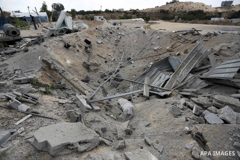 A Palestinian man inspects the site targeted by an Israeli air strike, in Khan younis in the southern Gaza strip, May 30, 2018. The Israeli Defense Forces said it launched more than 35 airstrikes targeting the militant g...
