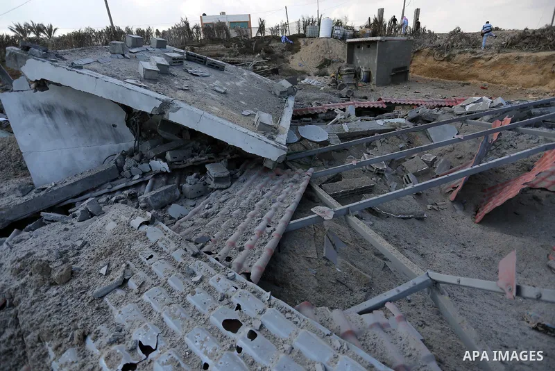A Palestinian man inspects the site targeted by an Israeli air strike, in Khan younis in the southern Gaza strip, May 30, 2018. The Israeli Defense Forces said it launched more than 35 airstrikes targeting the militant g...