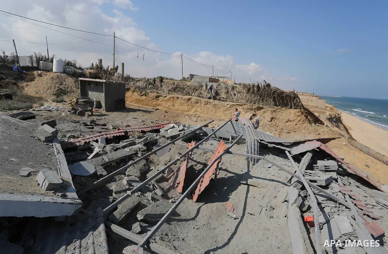 A Palestinian man inspects the site targeted by an Israeli air strike, in Khan younis in the southern Gaza strip, May 30, 2018. The Israeli Defense Forces said it launched more than 35 airstrikes targeting the militant g...