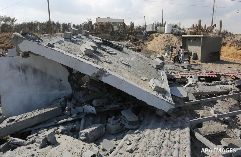 A Palestinian man inspects the site targeted by an Israeli air strike, in Khan younis in the southern Gaza strip, May 30, 2018. The Israeli Defense Forces said it launched more than 35 airstrikes targeting the militant g...