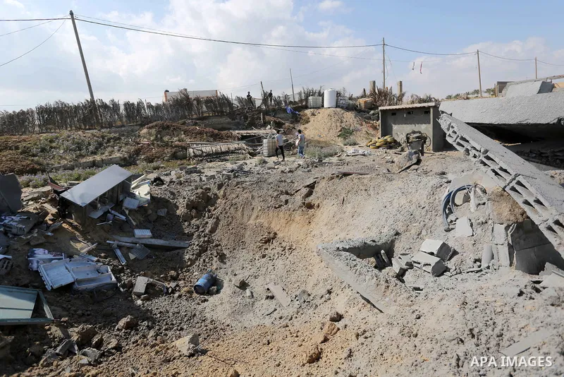 A Palestinian man inspects the site targeted by an Israeli air strike, in Khan younis in the southern Gaza strip, May 30, 2018. The Israeli Defense Forces said it launched more than 35 airstrikes targeting the militant g...